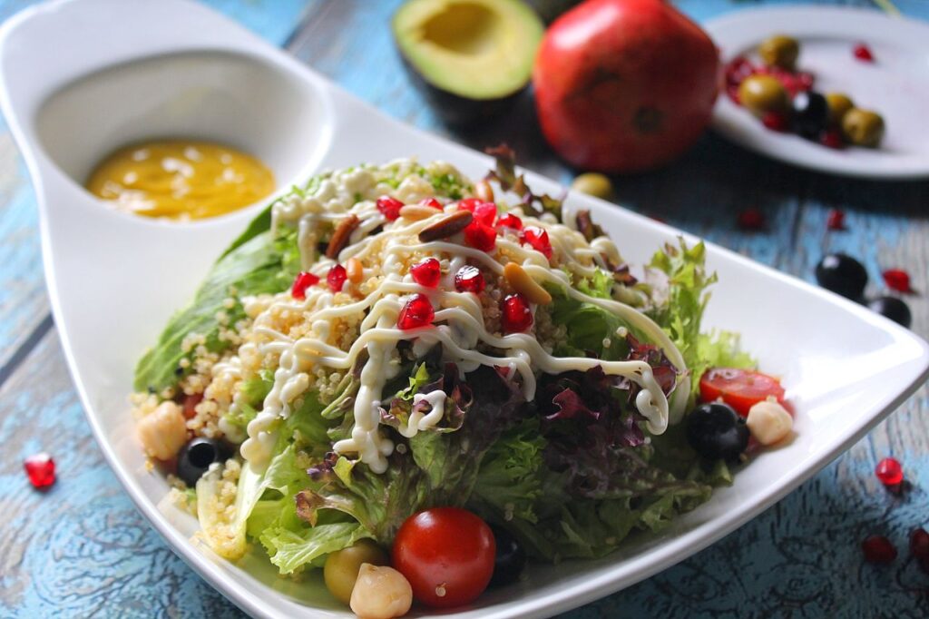 Vibrant quinoa salad with fresh vegetables, avocado, and pomegranate seeds, perfect for a healthy lunch.