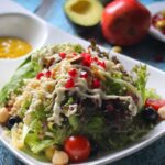 Vibrant quinoa salad with fresh vegetables, avocado, and pomegranate seeds, perfect for a healthy lunch.